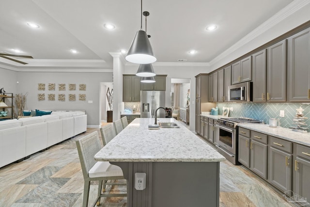 1397 Sabal Palm Dr, Gulf Breeze, FL 32563 - kitchen featuring appliances with stainless steel finishes, light stone counters, a sink, open floor plan, and decorative backsplash