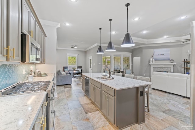 1397 Sabal Palm Dr, Gulf Breeze, FL 32563 - kitchen with crown molding, appliances with stainless steel finishes, a sink, gray cabinets, and open floor plan