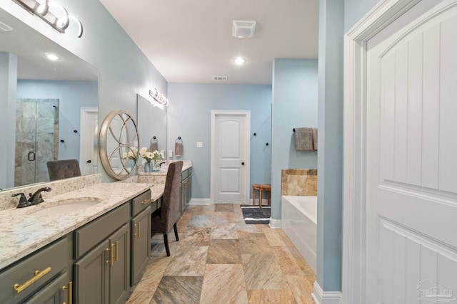 1397 Sabal Palm Dr, Gulf Breeze, FL 32563 - bathroom with a garden tub, visible vents, a stall shower, two vanities, and a sink