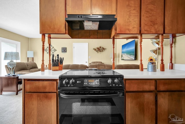 kitchen featuring under cabinet range hood, light countertops, black range with electric stovetop, and open floor plan