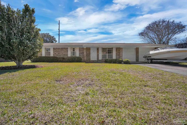 ranch-style house featuring a garage, brick siding, driveway, and a front lawn