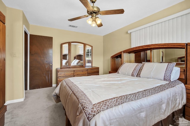 bedroom with carpet floors, visible vents, baseboards, and a ceiling fan