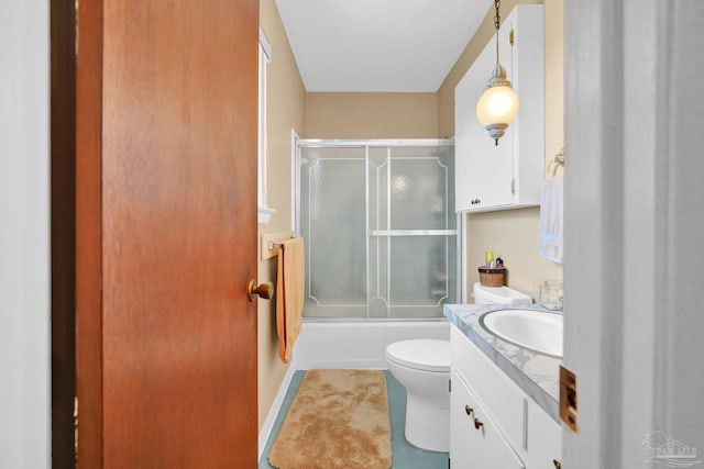 full bath with toilet, shower / bath combination with glass door, tile patterned floors, and vanity