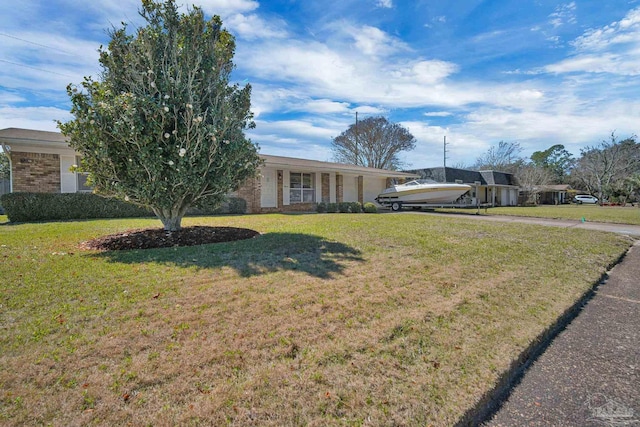 single story home featuring a front lawn and brick siding