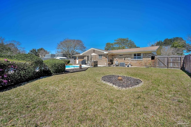 view of yard featuring a fenced backyard, a gate, cooling unit, and a fenced in pool