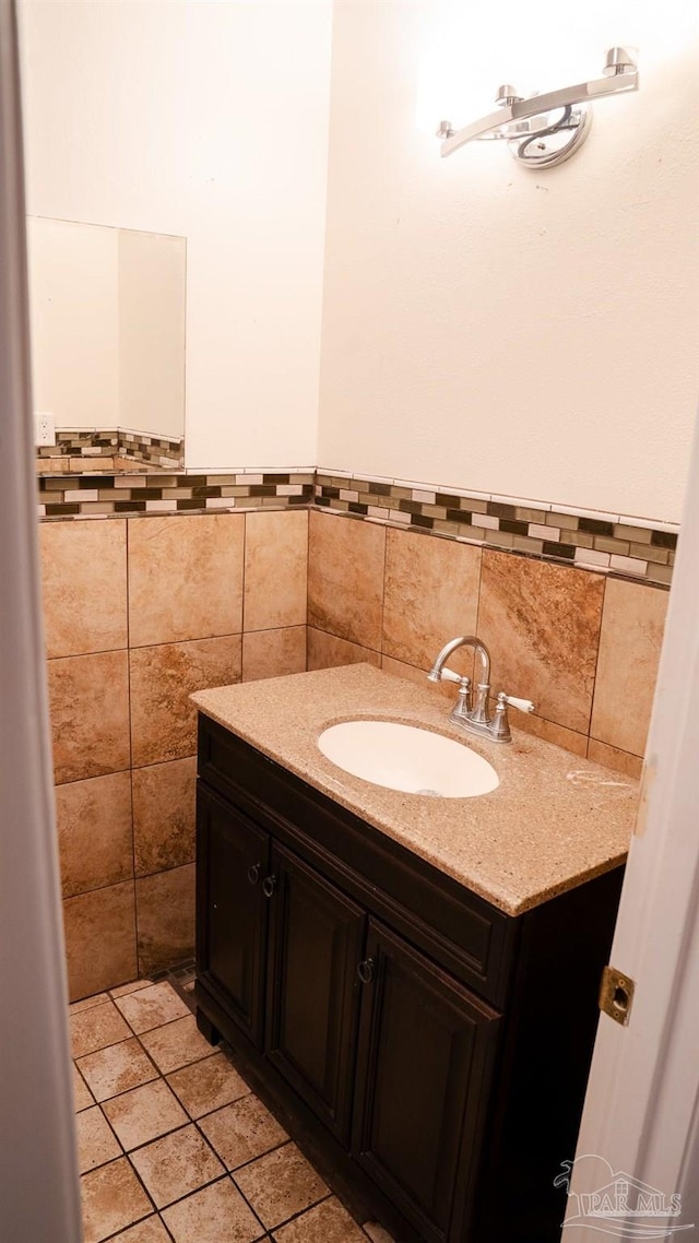 bathroom with tile walls and vanity