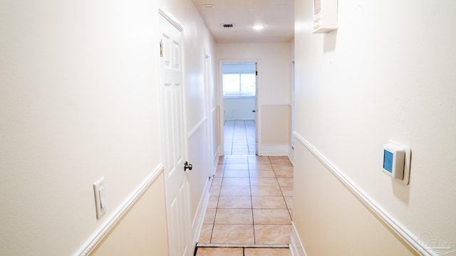 hallway featuring light tile patterned flooring