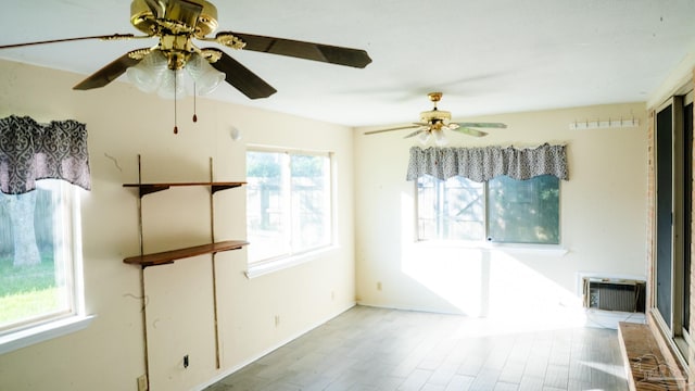 spare room featuring light hardwood / wood-style flooring and ceiling fan