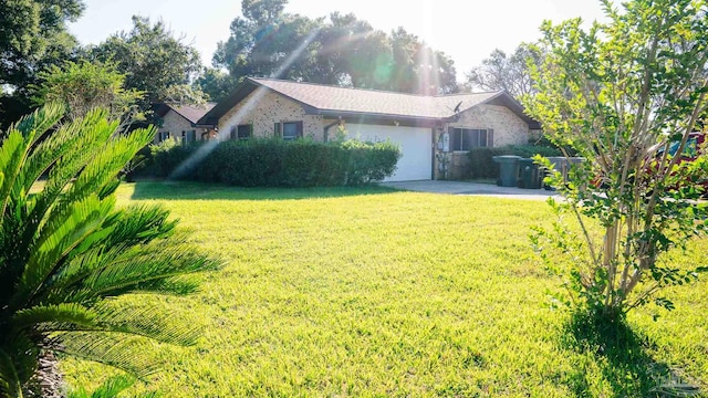 view of front of property featuring a front yard and a garage