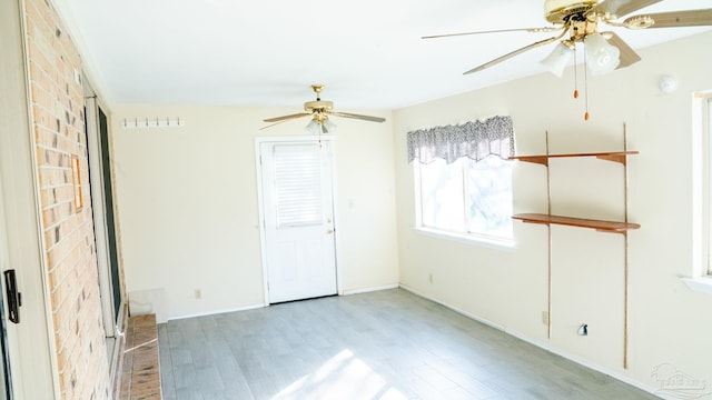 unfurnished room featuring light wood-type flooring and ceiling fan