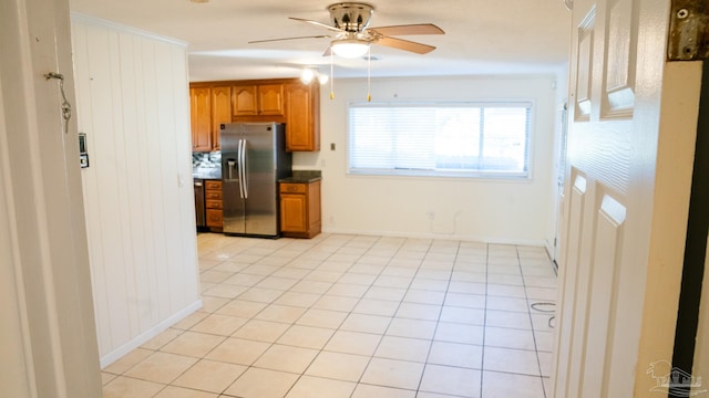 kitchen with ceiling fan, stainless steel refrigerator with ice dispenser, and light tile patterned floors