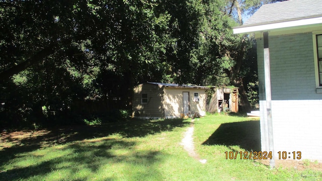 view of yard featuring an outbuilding and a shed