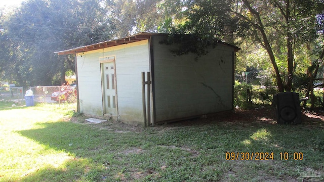 view of outdoor structure with a lawn