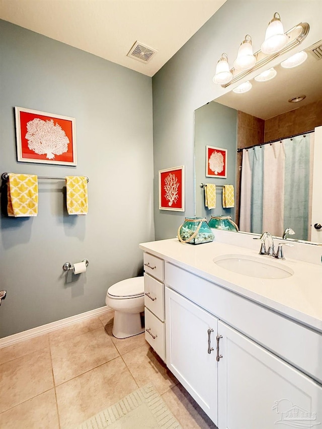 bathroom featuring visible vents, tile patterned flooring, vanity, baseboards, and toilet
