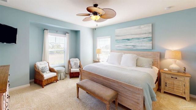 bedroom featuring baseboards, light carpet, and a ceiling fan