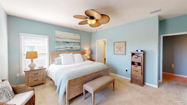 bedroom with visible vents, baseboards, ceiling fan, and light carpet