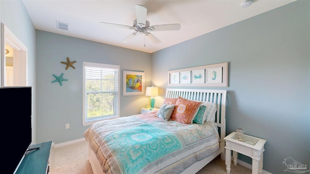 carpeted bedroom with visible vents, a ceiling fan, and baseboards