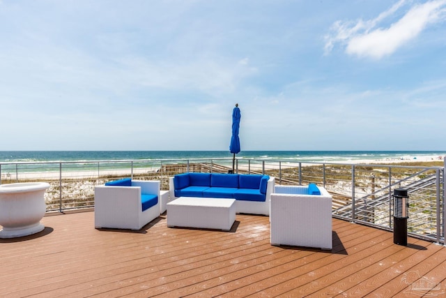 wooden deck with a beach view, a water view, and an outdoor hangout area