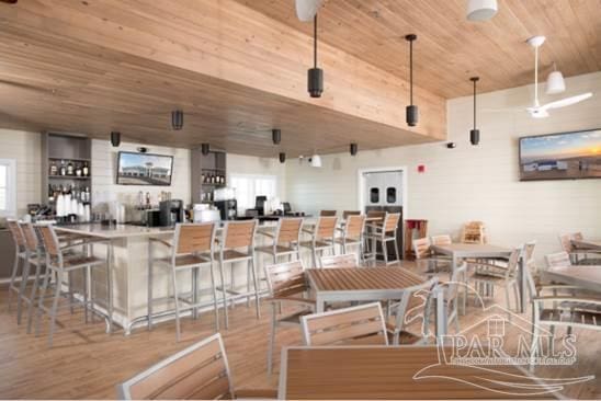 dining area featuring wooden ceiling and wood finished floors