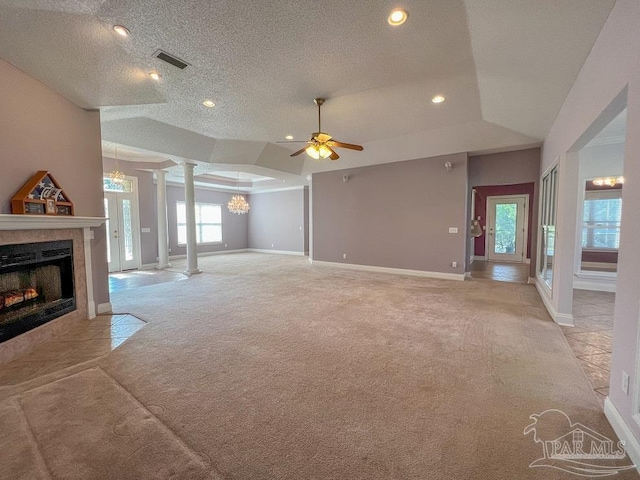 living room featuring ornate columns, light carpet, a textured ceiling, and ceiling fan