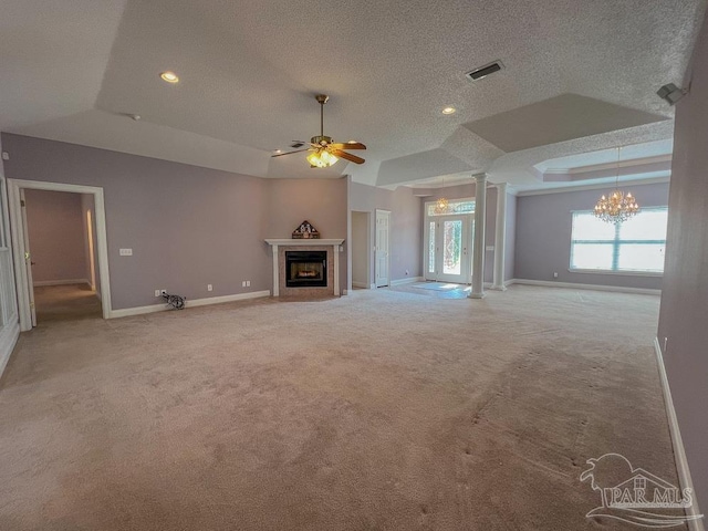 3615 Ward Basin Rd, Milton, FL 32583 - unfurnished living room featuring a tray ceiling, ornate columns, a chandelier, ceiling fan, and carpet