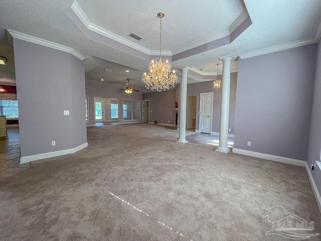 unfurnished living room featuring a raised ceiling, ceiling fan with notable chandelier, ornamental molding, and decorative columns