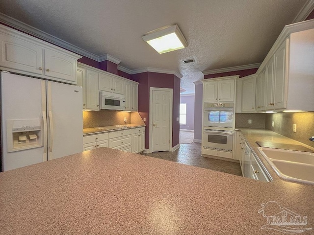 3615 Ward Basin Rd, Milton, FL 32583 - kitchen featuring white appliances, a sink, backsplash, white cabinetry, and crown molding