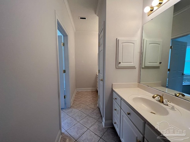 bathroom featuring ornamental molding, tile patterned floors, and vanity