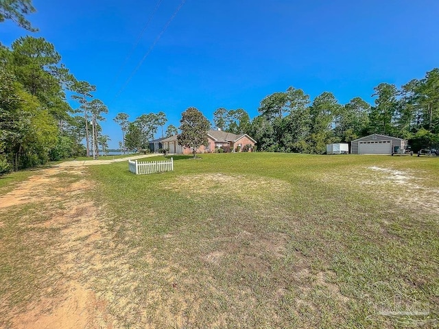 view of yard with an outbuilding and a garage