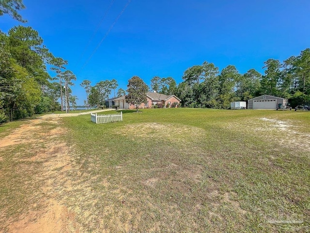3615 Ward Basin Rd, Milton, FL 32583 - view of green lawn with a detached garage