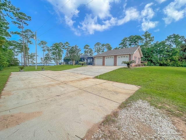 ranch-style home featuring a garage and a front lawn