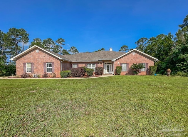 3615 Ward Basin Rd, Milton, FL 32583 - single story home with brick siding, a front lawn, and a chimney