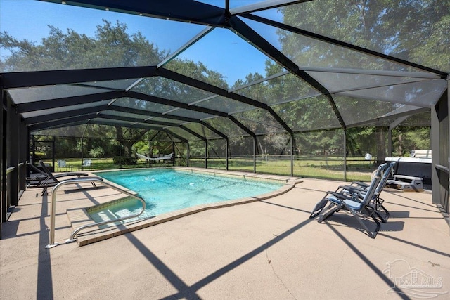 view of swimming pool with a lanai and a patio area