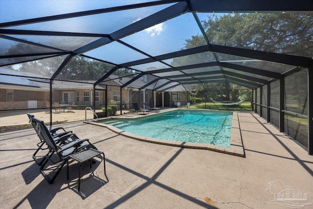 view of pool featuring a patio area and glass enclosure