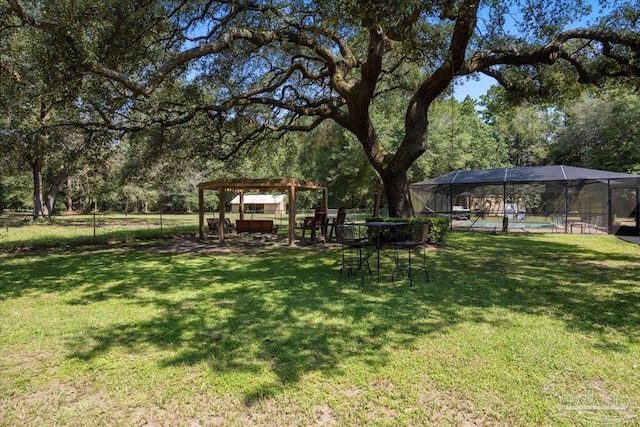 view of yard with a swimming pool and a pergola