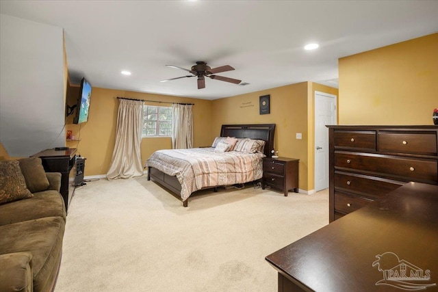 bedroom featuring light carpet and ceiling fan