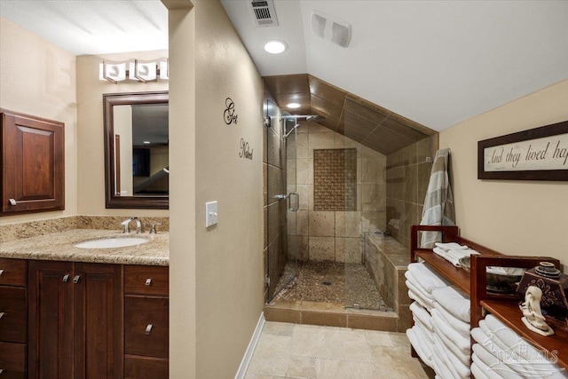 bathroom featuring vanity, lofted ceiling, and an enclosed shower