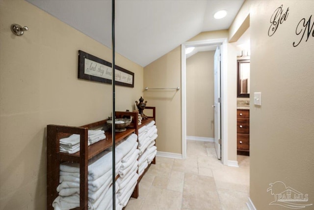 hallway with vaulted ceiling