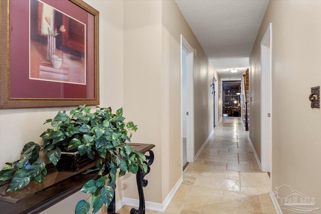 hallway featuring a textured ceiling