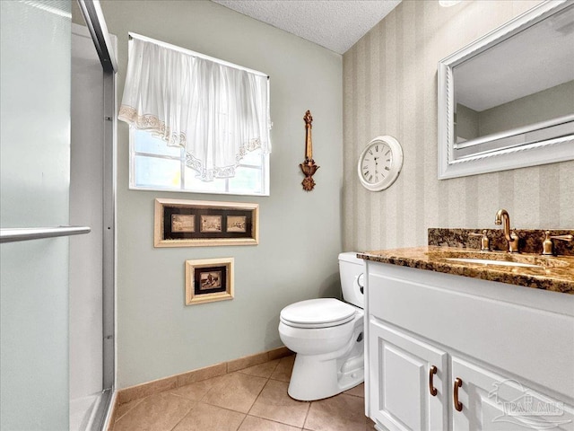 bathroom featuring vanity, tile patterned floors, a textured ceiling, and toilet