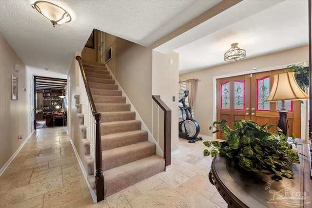 foyer featuring a textured ceiling