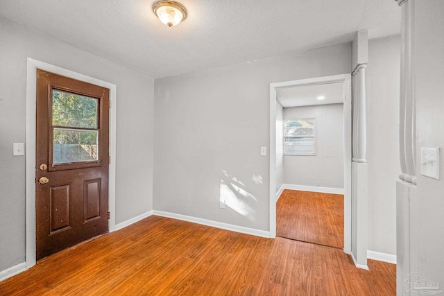 entrance foyer featuring a textured ceiling and light wood-type flooring