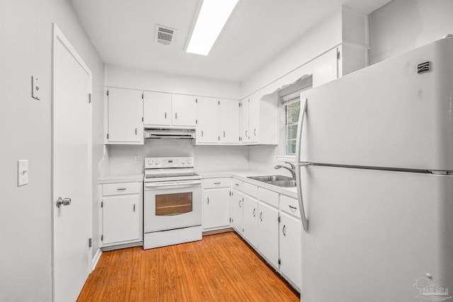 kitchen featuring white cabinets, light hardwood / wood-style floors, white appliances, and sink