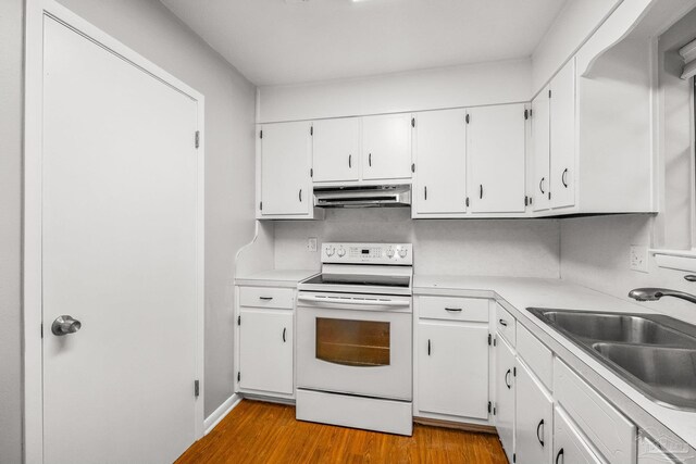 kitchen featuring white cabinetry, electric range, sink, and light hardwood / wood-style floors