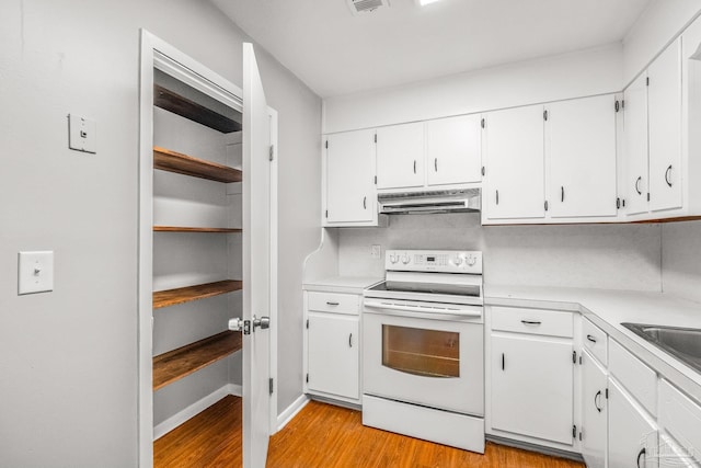 kitchen with light hardwood / wood-style flooring, white cabinets, and white electric stove