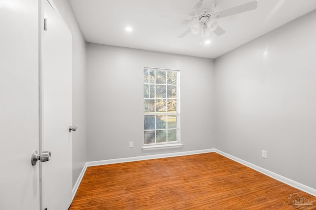 empty room featuring wood-type flooring and ceiling fan