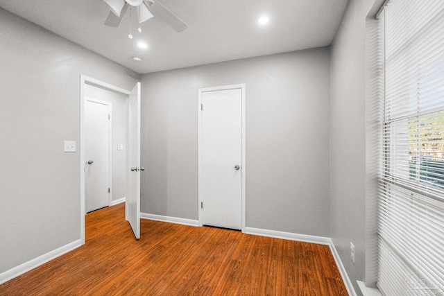 unfurnished bedroom featuring ceiling fan and hardwood / wood-style flooring