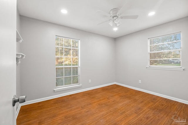 empty room with hardwood / wood-style flooring and ceiling fan