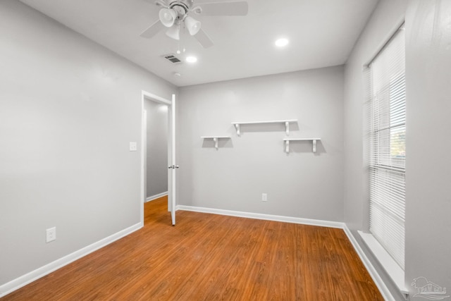 spare room featuring hardwood / wood-style floors and ceiling fan