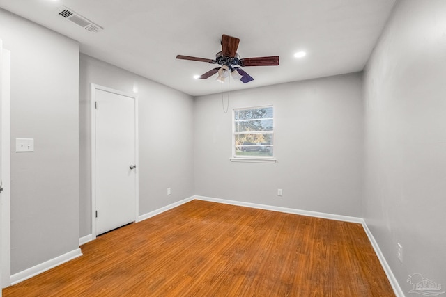 spare room with light wood-type flooring and ceiling fan